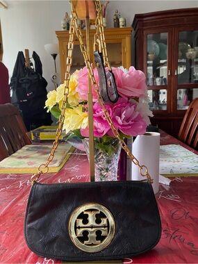 Black Leather Shoulder Bag with Gold-Tone Emblem and Chain Strap